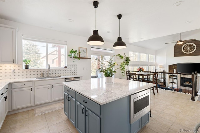 25362 E Indore Dr, Aurora, CO 80016 - kitchen featuring a sink, appliances with stainless steel finishes, backsplash, a ceiling fan, and vaulted ceiling
