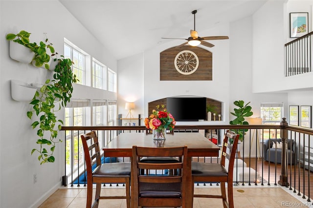 25362 E Indore Dr, Aurora, CO 80016 - dining space with high vaulted ceiling, ceiling fan, tile patterned floors, and baseboards