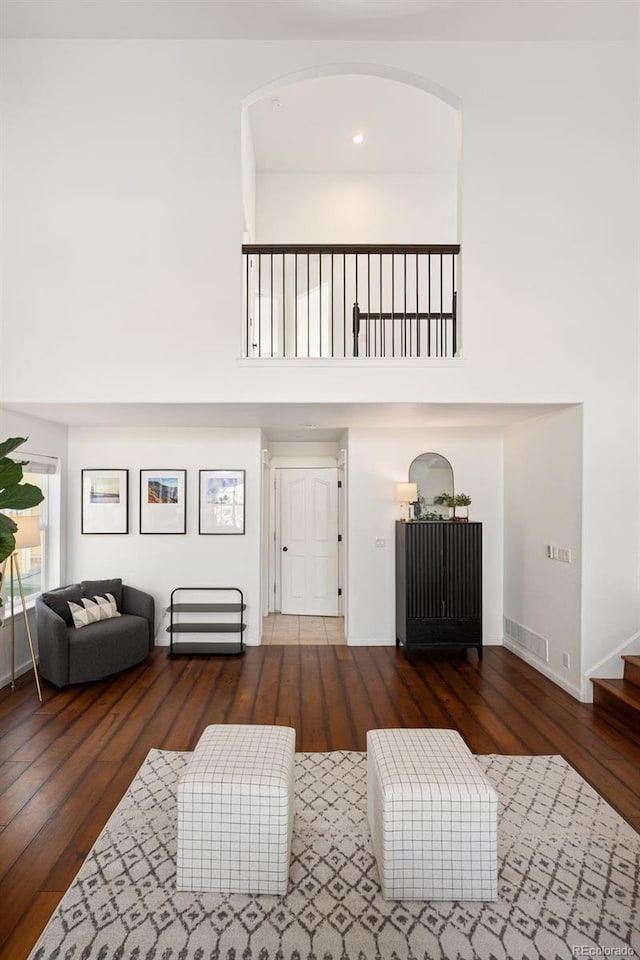 25362 E Indore Dr, Aurora, CO 80016 - living room with wood-type flooring, a high ceiling, and stairs