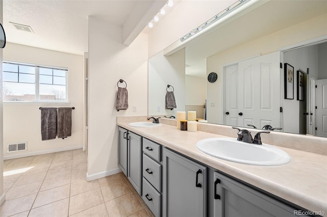 25362 E Indore Dr, Aurora, CO 80016 - bathroom featuring baseboards, double vanity, and tile patterned flooring