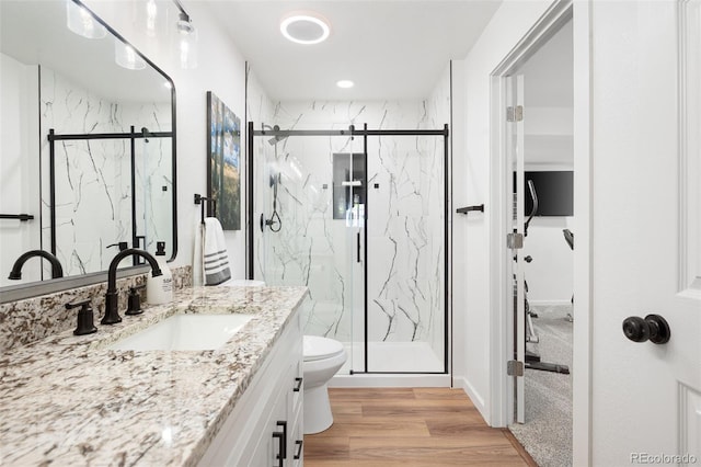 25362 E Indore Dr, Aurora, CO 80016 - bathroom with a marble finish shower, vanity, toilet, and recessed lighting