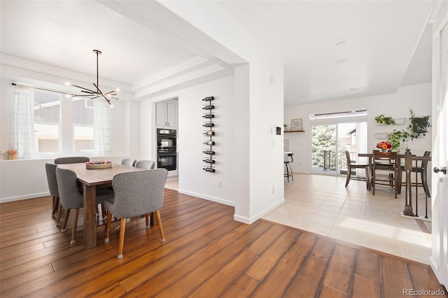 25362 E Indore Dr, Aurora, CO 80016 - dining space featuring a chandelier and light wood finished floors