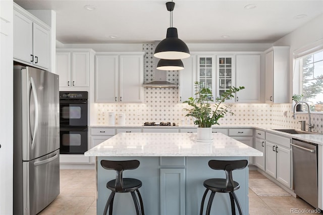 25362 E Indore Dr, Aurora, CO 80016 - kitchen featuring appliances with stainless steel finishes, a breakfast bar, light tile patterned flooring, a center island, and recessed lighting