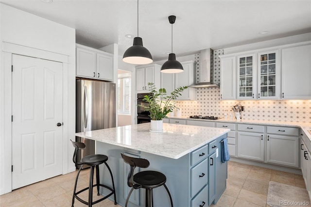 25362 E Indore Dr, Aurora, CO 80016 - kitchen featuring wall chimney exhaust hood, freestanding refrigerator, a center island, decorative backsplash, and glass insert cabinets