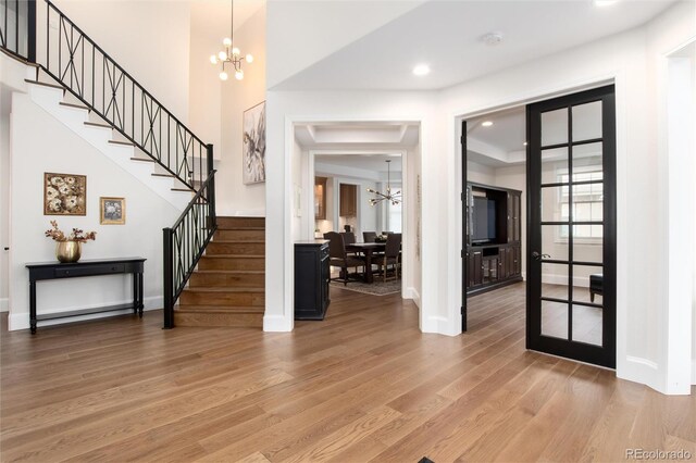 entryway with an inviting chandelier and hardwood / wood-style floors