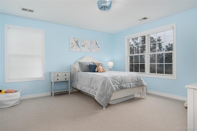 bedroom featuring multiple windows and carpet flooring