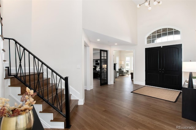 foyer featuring dark hardwood / wood-style floors and a high ceiling