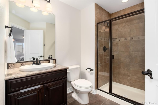 bathroom with walk in shower, tile patterned floors, vanity, and toilet