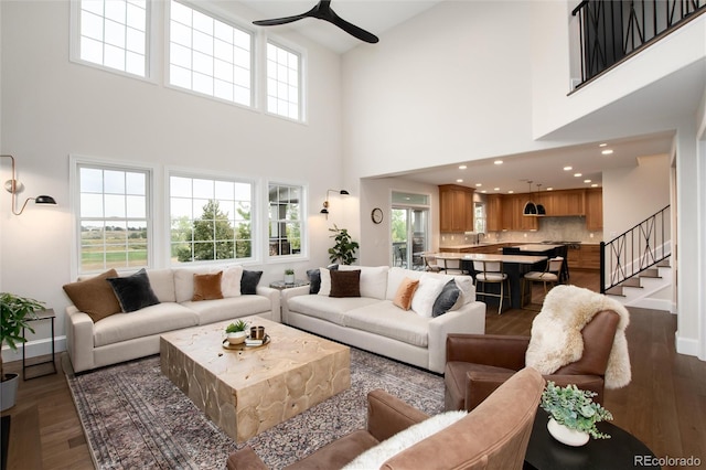 living room featuring ceiling fan and dark hardwood / wood-style flooring