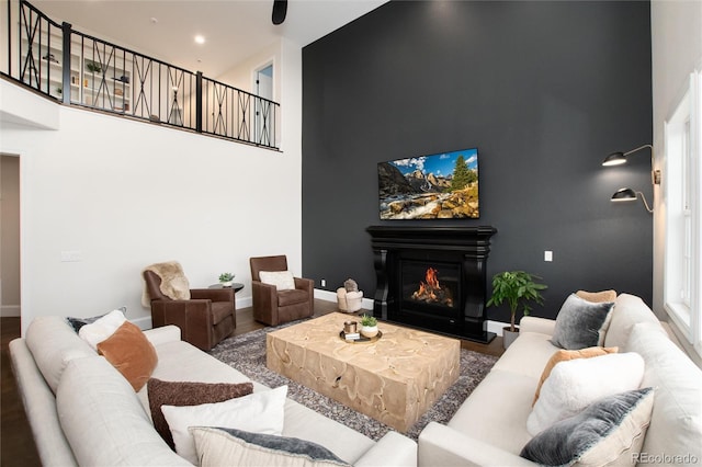 living room with a towering ceiling and hardwood / wood-style floors