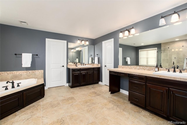 bathroom with vanity and shower with separate bathtub