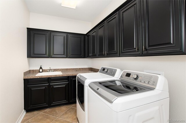 clothes washing area featuring sink, washer and clothes dryer, cabinets, and light tile patterned flooring