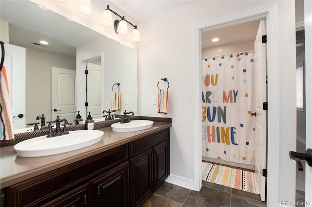 bathroom with a shower with curtain, tile patterned floors, and vanity