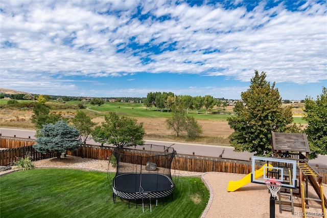 view of yard with a playground and a trampoline