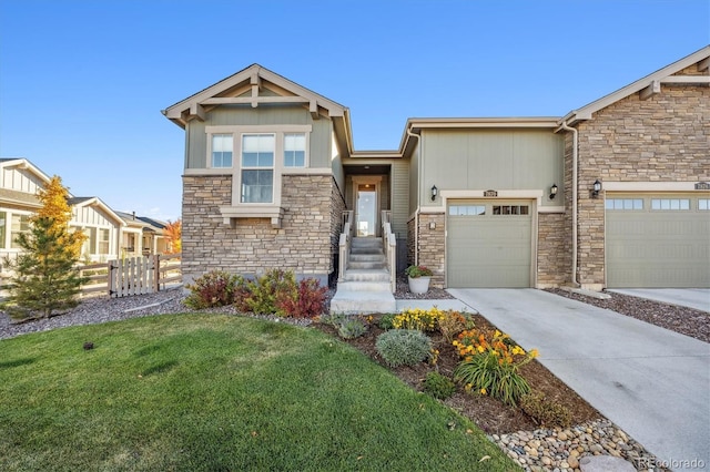 craftsman house with a garage and a front yard