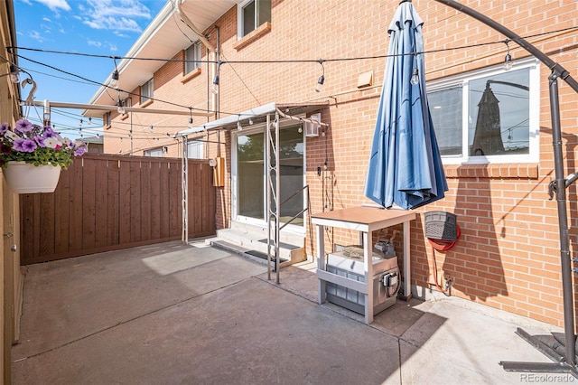 view of patio / terrace featuring entry steps and fence