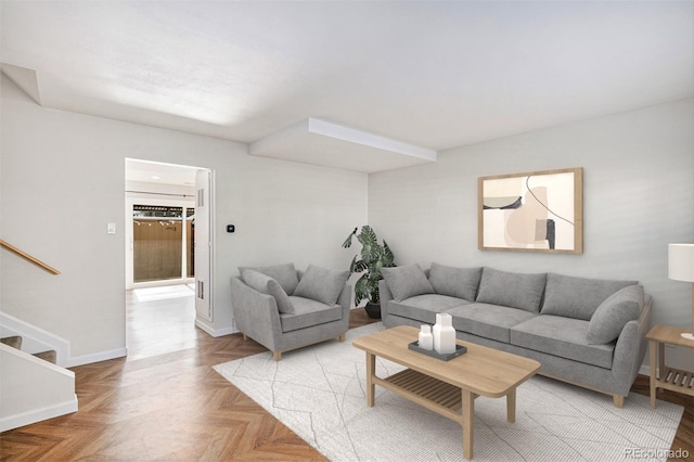 living area featuring stairs and baseboards