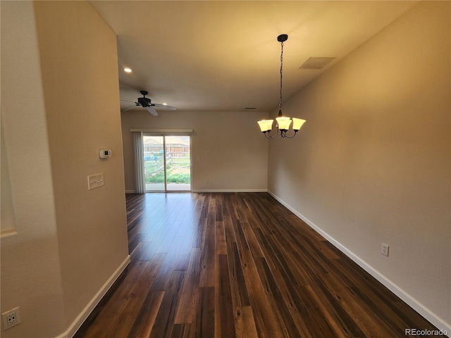unfurnished room featuring baseboards, dark wood-style flooring, visible vents, and ceiling fan with notable chandelier