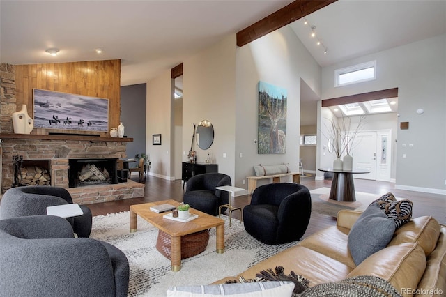 living room with baseboards, a fireplace, high vaulted ceiling, and wood finished floors