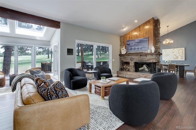 living area featuring dark wood-style flooring, a skylight, a wealth of natural light, and a fireplace