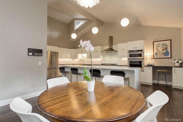 dining space with dark wood-type flooring, baseboards, high vaulted ceiling, and beamed ceiling