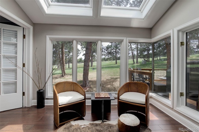 sunroom / solarium with wood finished floors and a skylight