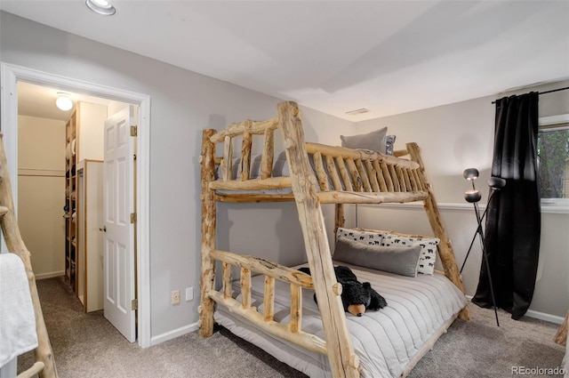 carpeted bedroom featuring baseboards