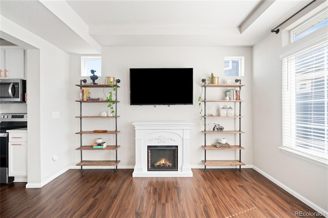 21925 E 44th Pl, Aurora, CO 80019 - unfurnished living room featuring dark wood finished floors and a warm lit fireplace