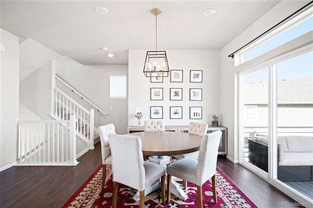 21925 E 44th Pl, Aurora, CO 80019 - dining area with dark wood-style floors, a chandelier, stairway, and recessed lighting