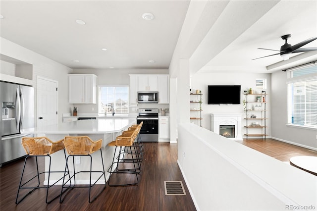 21925 E 44th Pl, Aurora, CO 80019 - kitchen with appliances with stainless steel finishes, plenty of natural light, open floor plan, light countertops, and recessed lighting