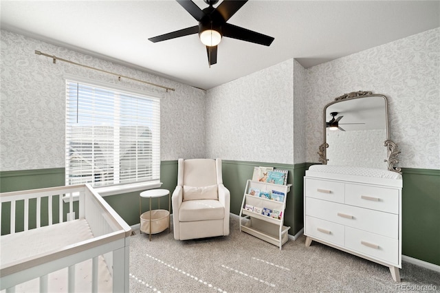 21925 E 44th Pl, Aurora, CO 80019 - bedroom featuring a wainscoted wall, wallpapered walls, a crib, and ceiling fan