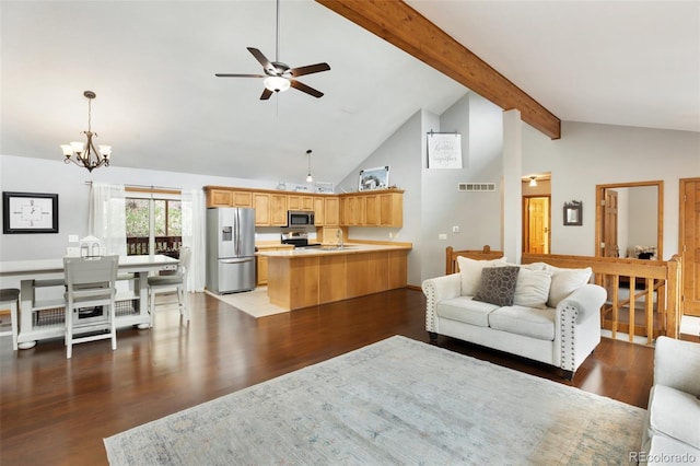 120 Red Rock Ct, Woodland Park, CO 80863 - living area with ceiling fan, a chandelier, beamed ceiling, wood finished floors, and high vaulted ceiling