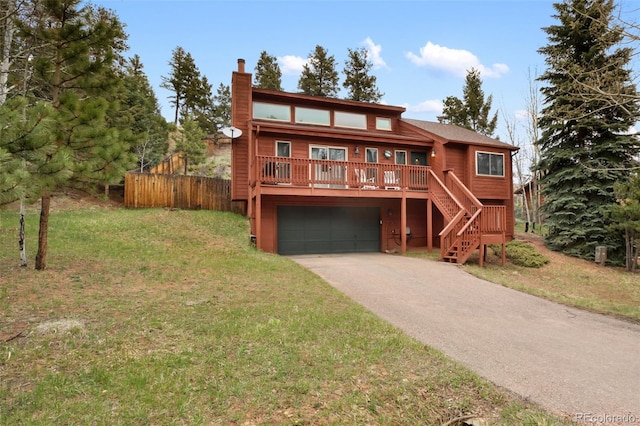 120 Red Rock Ct, Woodland Park, CO 80863 - rustic home featuring an attached garage, driveway, stairway, and a chimney