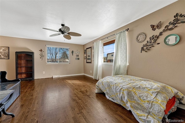 bedroom featuring ceiling fan and dark hardwood / wood-style floors