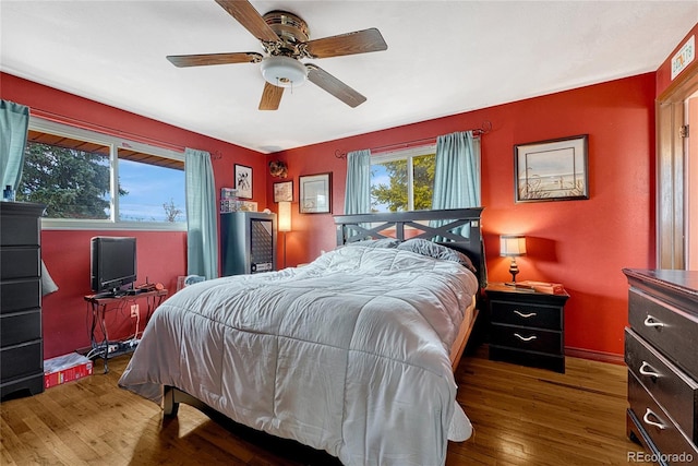 bedroom with ceiling fan and dark hardwood / wood-style flooring