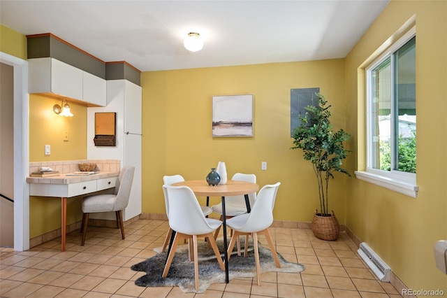dining area with baseboards, visible vents, and light tile patterned floors