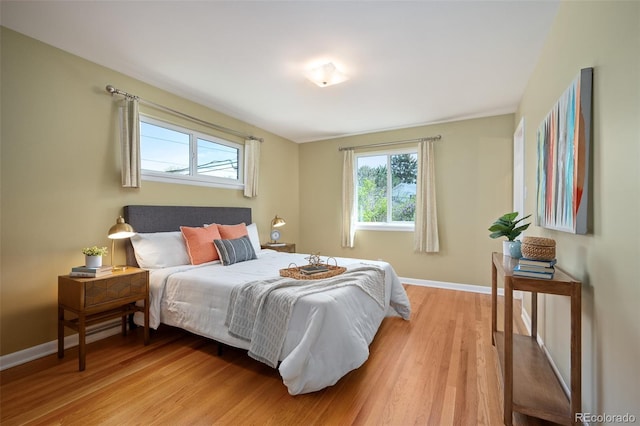 bedroom featuring baseboards and light wood-style flooring