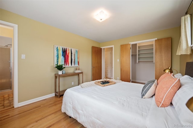 bedroom featuring light wood finished floors, baseboards, and a closet
