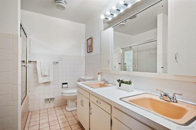 full bathroom with visible vents, tile patterned floors, toilet, and a sink
