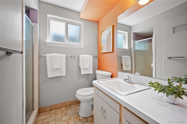 full bathroom with baseboards, a shower stall, toilet, and vanity