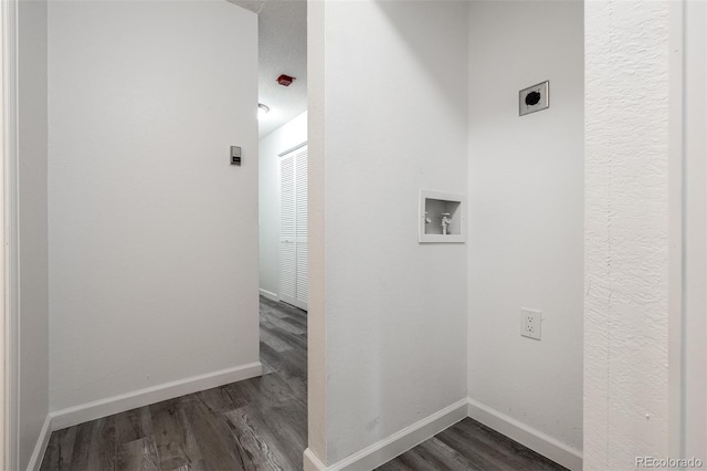 interior space featuring hookup for a washing machine, electric dryer hookup, and dark wood-type flooring