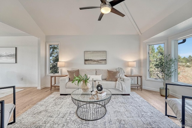 living room featuring ceiling fan, vaulted ceiling, and light hardwood / wood-style flooring