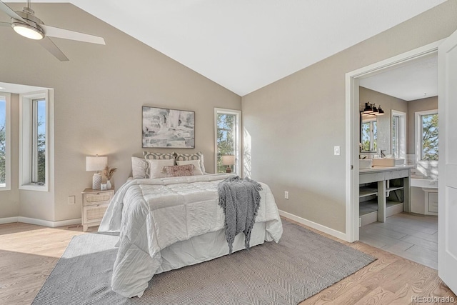 bedroom with ceiling fan, lofted ceiling, and light wood-type flooring