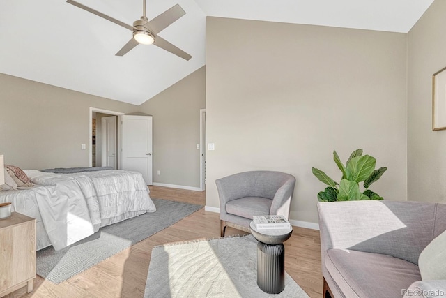 bedroom featuring ceiling fan, lofted ceiling, and light hardwood / wood-style floors