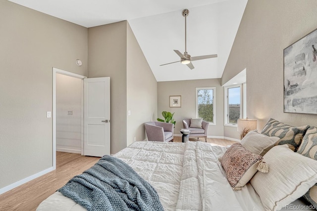 bedroom with ceiling fan, vaulted ceiling, and light hardwood / wood-style floors