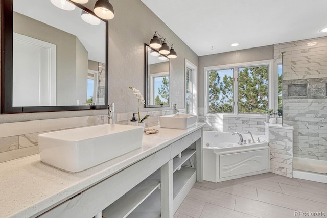 bathroom featuring vanity and shower with separate bathtub