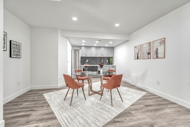 dining area with hardwood / wood-style floors