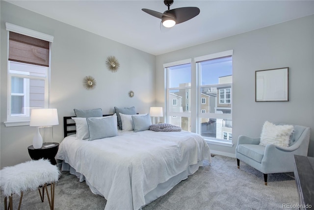 carpeted bedroom with multiple windows and ceiling fan