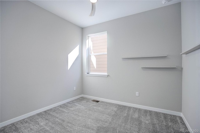 carpeted spare room featuring ceiling fan