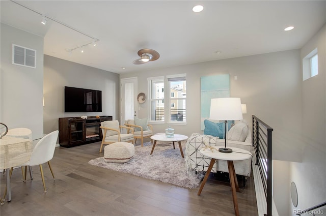 living room featuring hardwood / wood-style floors and track lighting